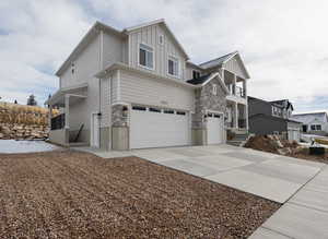 View of side of home with a garage and a balcony