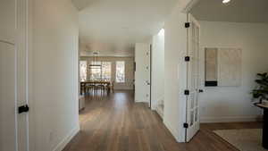 Hallway with hardwood / wood-style flooring