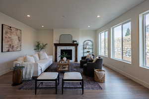 Living room featuring a fireplace, hardwood / wood-style floors, and plenty of natural light