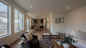 Living room featuring plenty of natural light and dark wood-type flooring