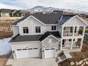 View of front of property with a mountain view, a garage, and a balcony