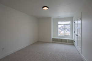 Empty room with light colored carpet