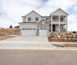 View of front facade with a porch and a garage