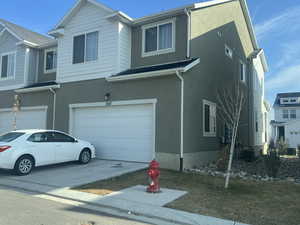 View of front of property with cooling unit and a garage