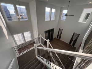 Stairs with a towering ceiling and a chandelier