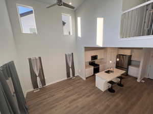 Kitchen featuring sink, ceiling fan, appliances with stainless steel finishes, white cabinets, and dark hardwood / wood-style flooring