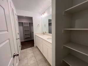 Bathroom with vanity, tile patterned flooring, and a textured ceiling