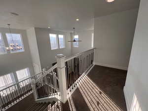 Hall with a notable chandelier and carpet