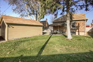 View of yard featuring a patio area and an outbuilding