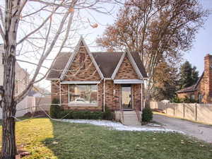 Tudor house featuring a front yard