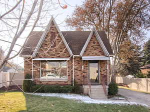 Tudor house featuring a front yard