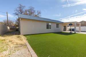 Rear view of house featuring central AC unit, a yard, and a patio