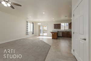 Kitchen with dishwasher, ceiling fan with notable chandelier, light tile patterned flooring, and decorative light fixtures