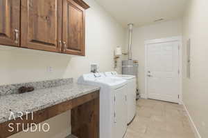 Clothes washing area with separate washer and dryer, electric panel, and cabinets