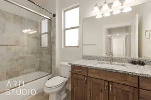 Full bathroom featuring shower / bath combination with glass door, tile patterned floors, vanity, and toilet