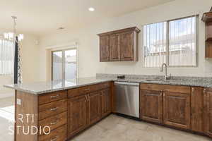 Kitchen featuring dishwasher, kitchen peninsula, plenty of natural light, and sink