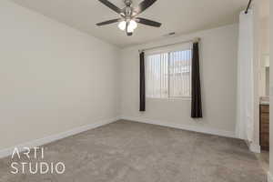 Spare room with light carpet and ceiling fan