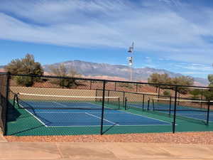 View of tennis court with a mountain view