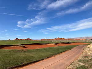 View of home's community with a mountain view and a yard