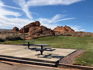 View of property's community with a mountain view and a yard