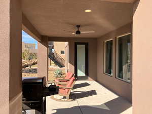 View of patio with ceiling fan and a grill