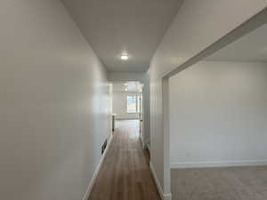 Hall with light hardwood / wood-style flooring