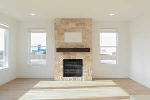 Unfurnished living room with a fireplace and hardwood / wood-style flooring