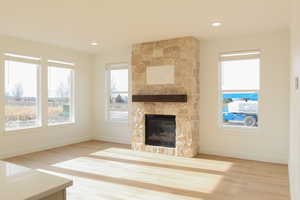 Unfurnished living room with a fireplace, hardwood / wood-style floors, and plenty of natural light