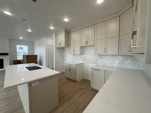 Kitchen featuring a center island, backsplash, and light hardwood / wood-style flooring