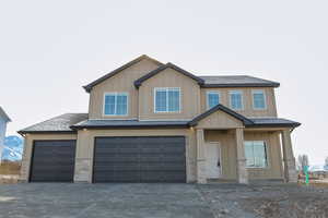 View of front facade featuring a garage