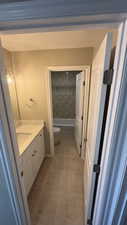 Full bathroom featuring tiled shower / bath, tile patterned flooring, vanity, and toilet