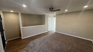 Interior space featuring ceiling fan and dark wood-type flooring