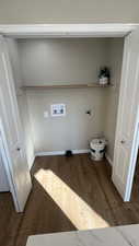 Laundry area with hookup for an electric dryer, dark hardwood / wood-style floors, and hookup for a washing machine