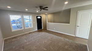 Interior space with ceiling fan and dark hardwood / wood-style flooring