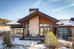 Snow covered property featuring a patio