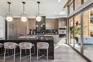 Kitchen featuring appliances with stainless steel finishes, plenty of natural light, and dark stone counters