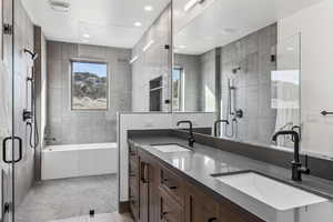 Bathroom featuring tile patterned flooring, vanity, independent shower and bath, and tile walls