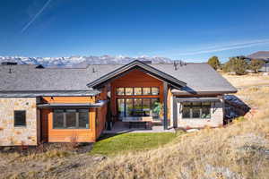 Back of property featuring a patio area and a mountain view