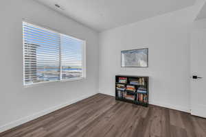 Third bedroom has dark hardwood / wood-style flooring, mountain views