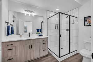 En suite bathroom with walk in closet for primary bedroom