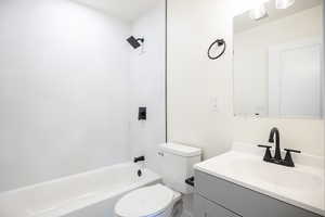 Full bathroom featuring bathing tub / shower combination, vanity, and toilet