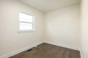 Spare room featuring dark hardwood / wood-style flooring