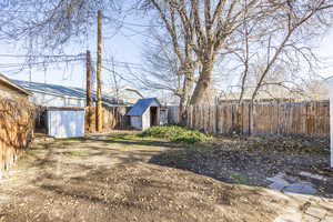 View of yard with a storage unit