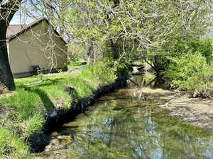 View of yard with a water view