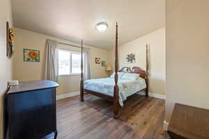 Bedroom with a textured ceiling and hardwood / wood-style flooring