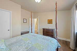 Bedroom with dark hardwood / wood-style floors