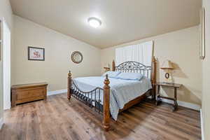 Bedroom featuring wood-type flooring and a textured ceiling