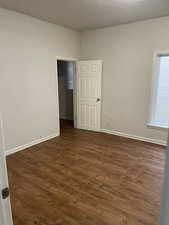 Empty room with dark hardwood / wood-style floors