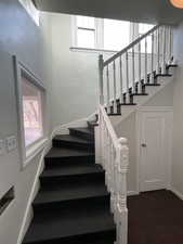 Staircase featuring hardwood / wood-style flooring