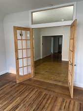 Interior space with french doors and dark hardwood / wood-style floors